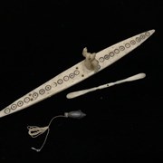 Cover image of Untitled (Ivory kayak with ivory figure, paddle and stone seal)